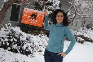 Dr. DiGiulio standing outside in the snow with a Cornerstone Family Dentistry sign